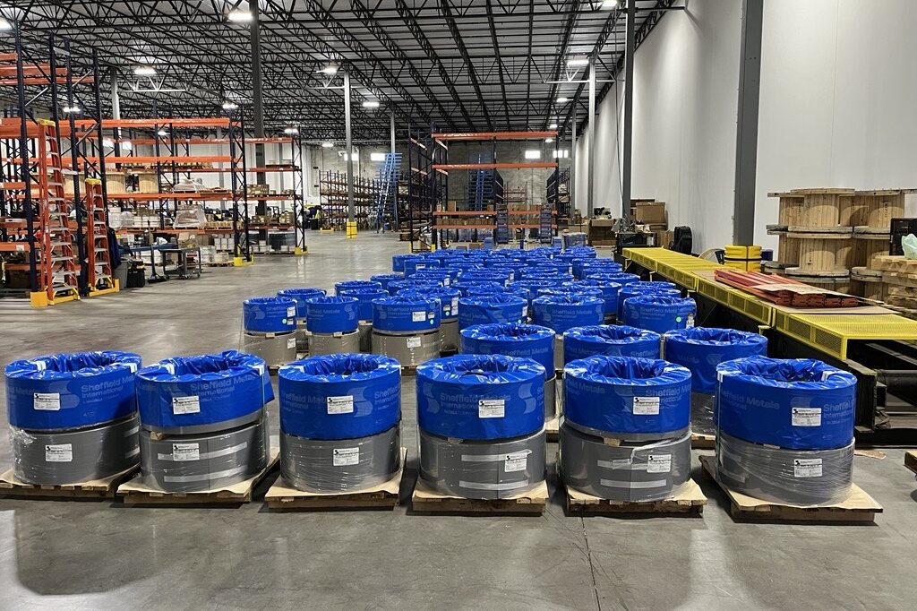 Sheffield Metals aluminum coils with branded blue wraps