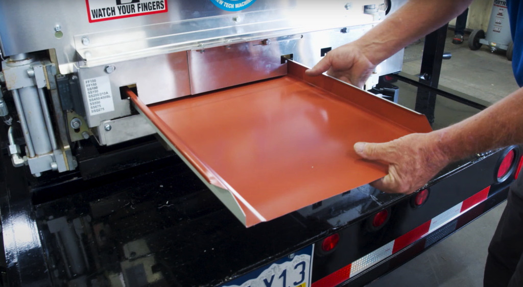 Fabricating a metal roofing panel on a rollforming machine