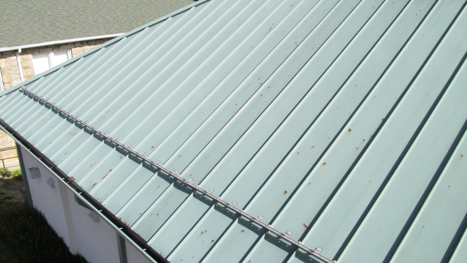 Close up of a light blue roof showing signs of corrosion