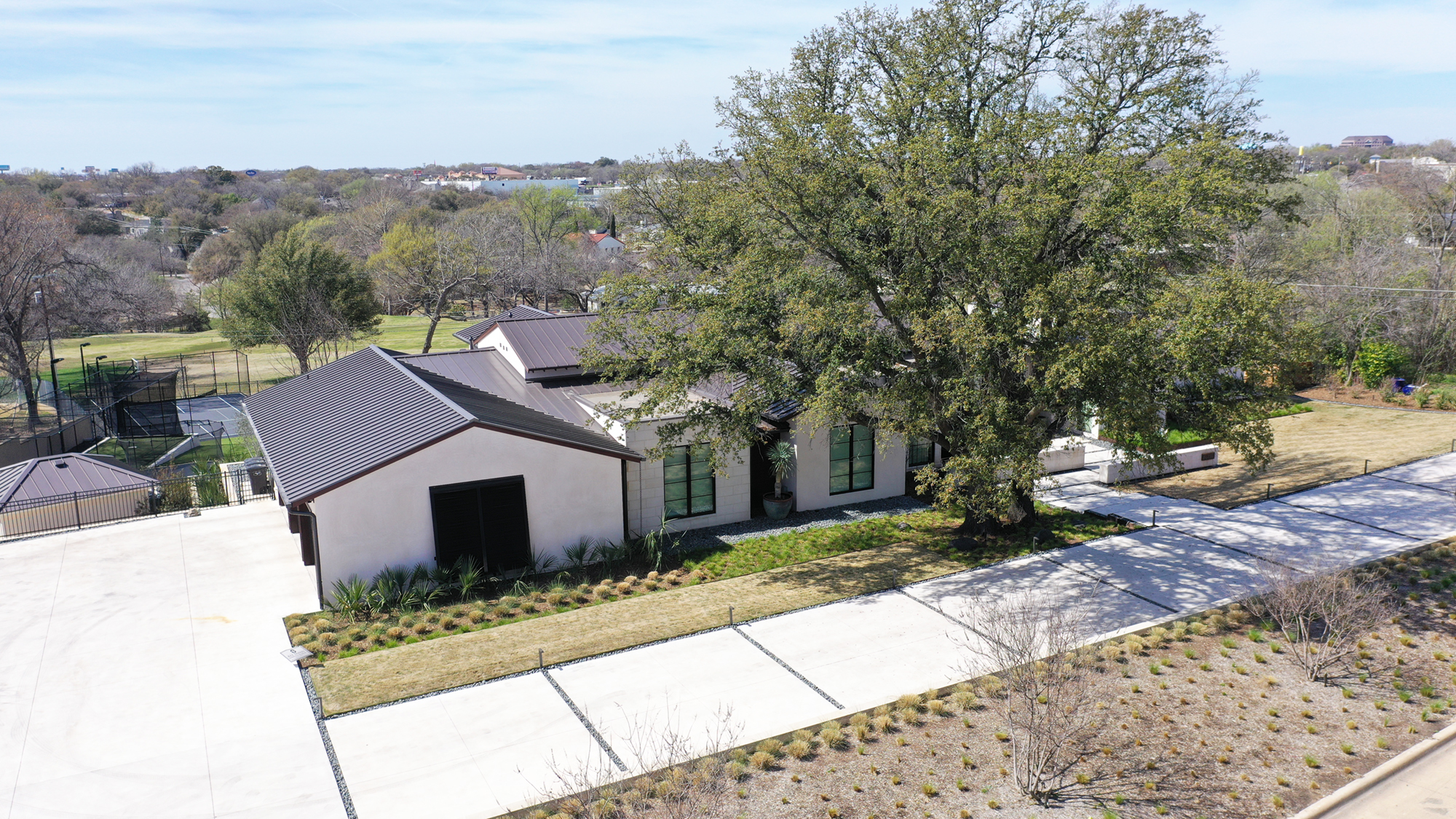 A large residential home with a black metal roof