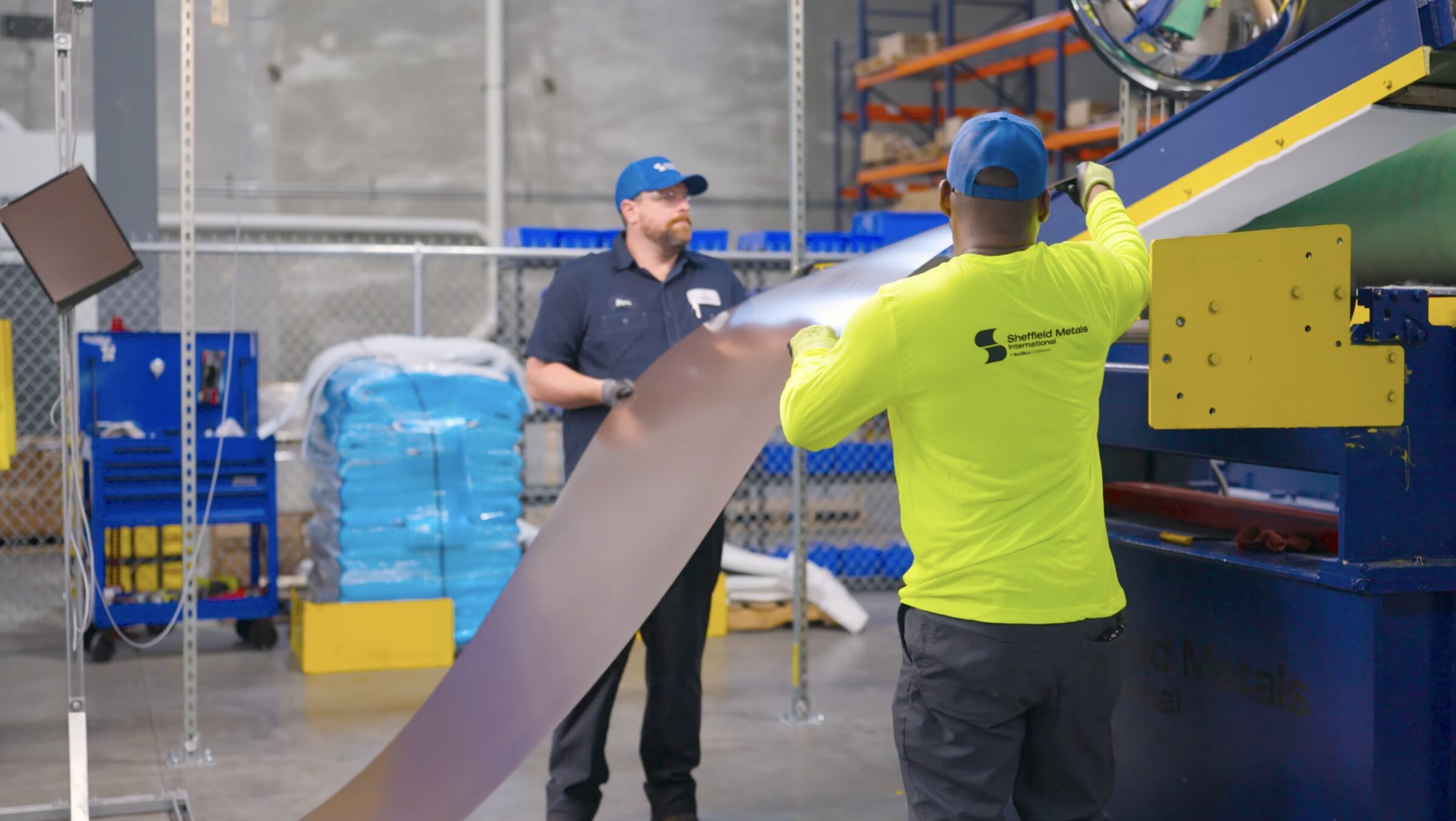 Sheffield Metals team members processing metal sheet at the East Chicago service center